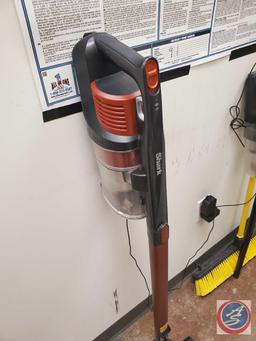 Assorted cleaning equipment. Including Shark handheld vacuum, push broom, broom, squeegee, floor