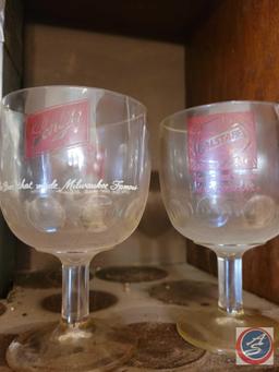 Assortment of beer advertisement glasses, brands include Schlitz, Falstaff, and Hamms. Also included