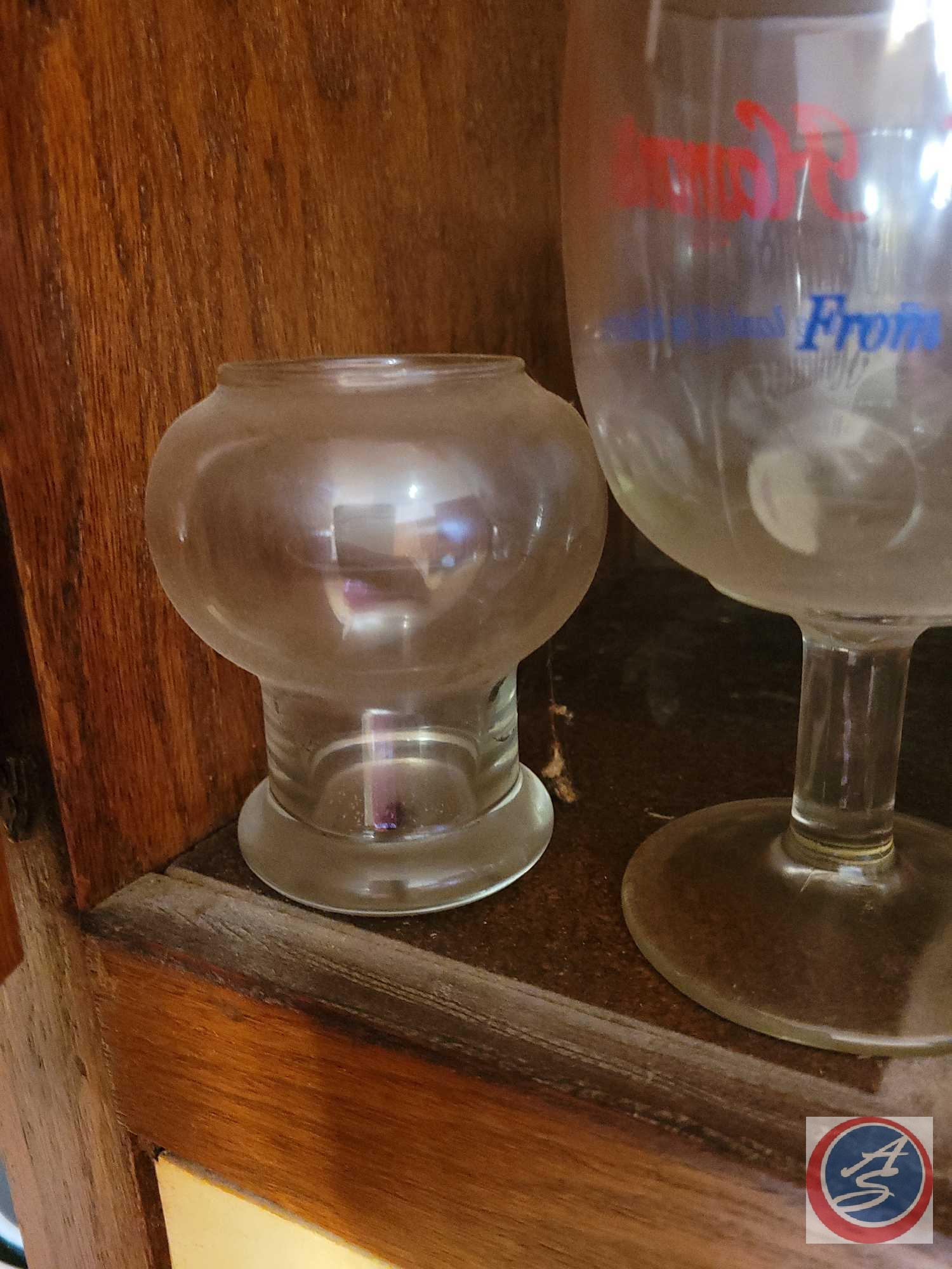 Assortment of beer advertisement glasses, brands include Schlitz, Falstaff, and Hamms. Also included