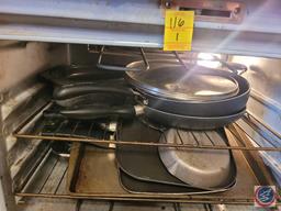 Assortment of pans and roasters. Including skillets, square stovetop griddles, and cooky sheet.