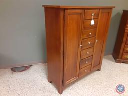 Wood Cabinet with 2 doors one to hang jewelry on, 7 drawers, 3 shelves on each side for clothing,