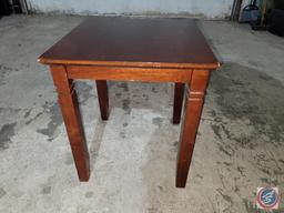 small corner table and wicker chair