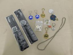 (2) EIGER WRIST WATCHES & ASSORTED KEY CHAINS, HAT PINS & NECKLACE