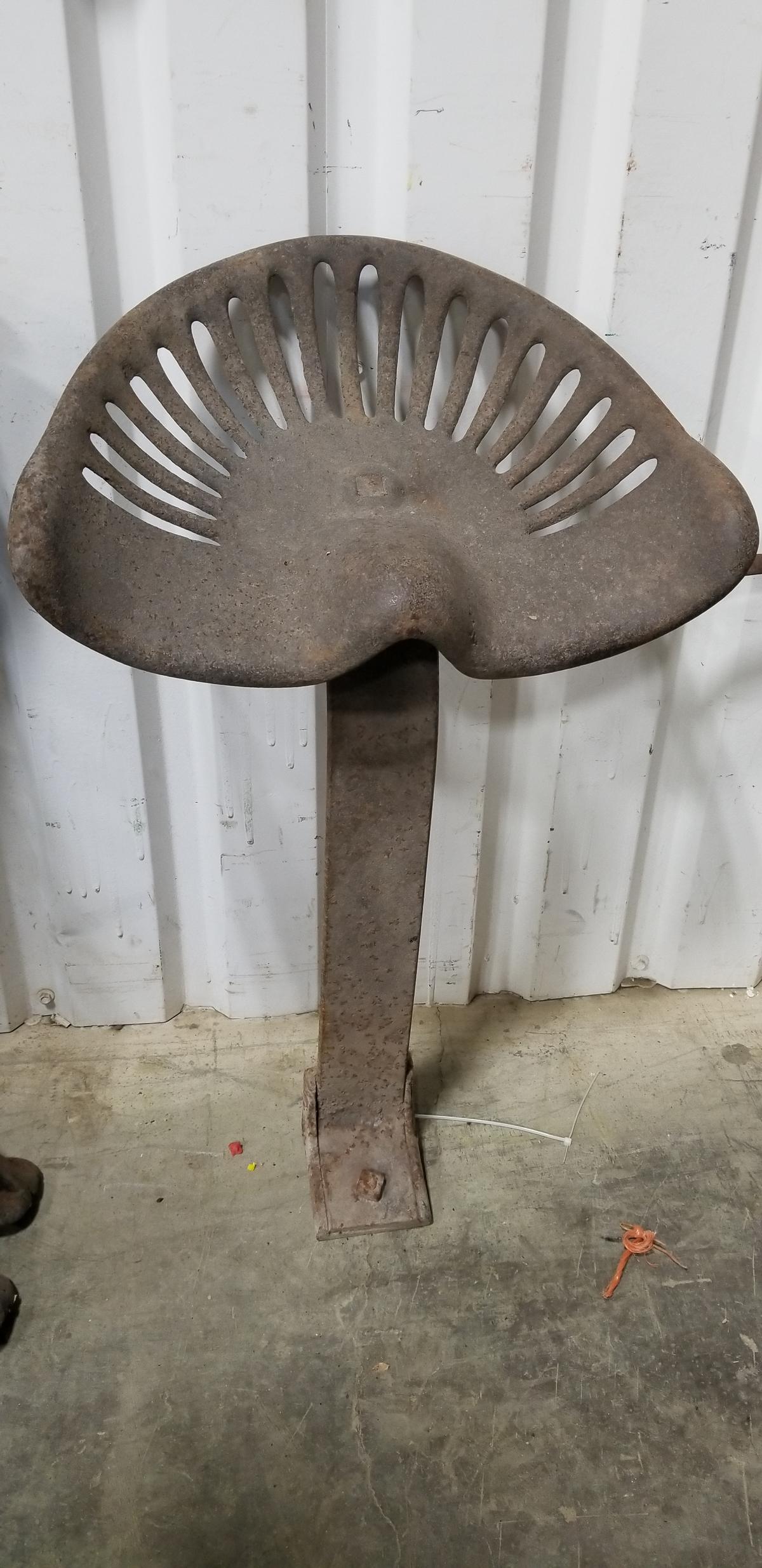 UNMARKED STEEL IMPLEMENT OR TRACTOR SEAT