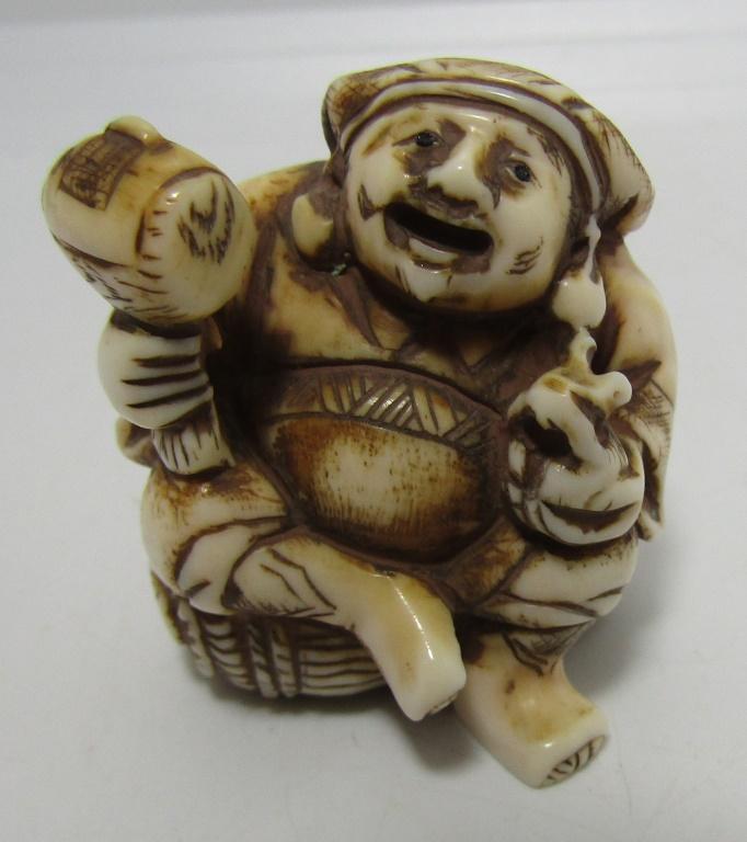 CARVED NETSUKE FOSSIL CARVER WITH MALLET