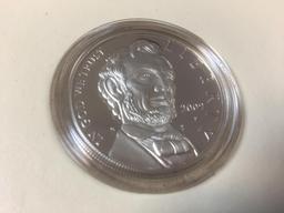 The Abraham Lincoln, Silver Proof Coin and Four, 2009 Pennies