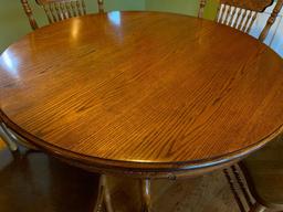 Round Oak Table W/(4) Matching Press-Back Spindle Chairs