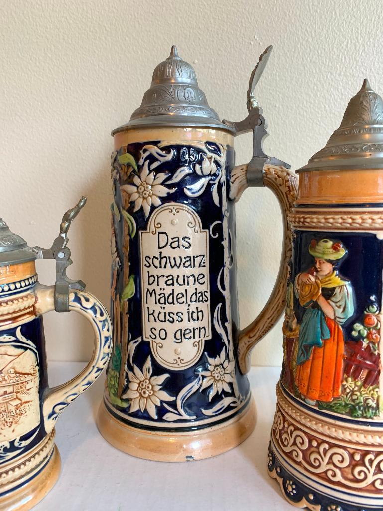 3 German Beer Steins. One is a Music Box. The Tallest is 11" Tall