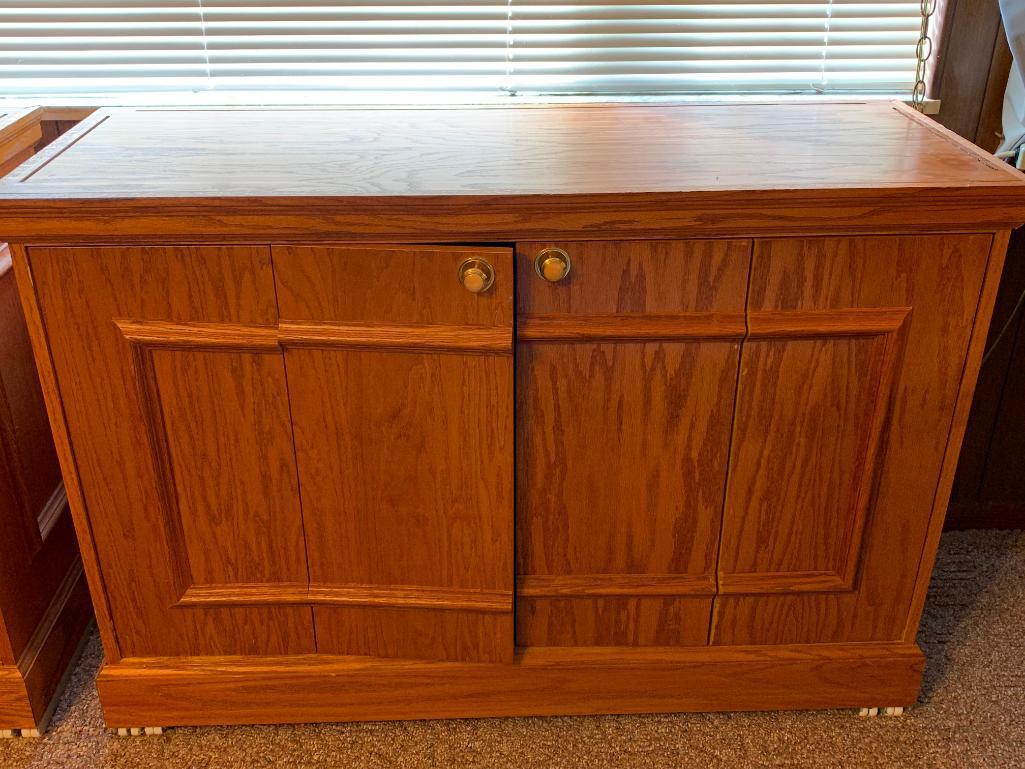 Credenza w/Bi-Fold Doors. This is 33" T x 48" W x 18" D. This has Some Water Damage on Top