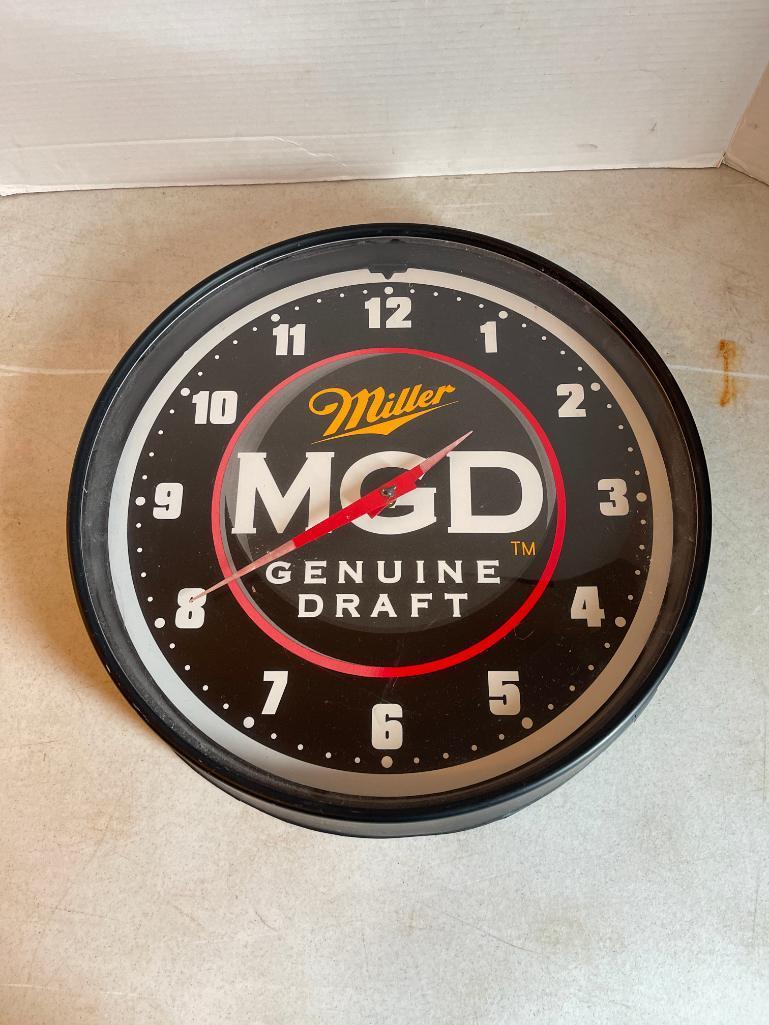 Plastic MGD Wall Clock, No Battery to Test, It is as-is, Some Damage to Back as Shown