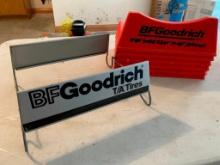 Three Plastic and One Metal Goodrich Tire Stands