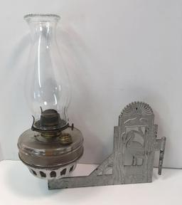 Antique hanging kerosene lamp with cast iron bracket