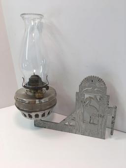 Antique hanging kerosene lamp with cast iron bracket