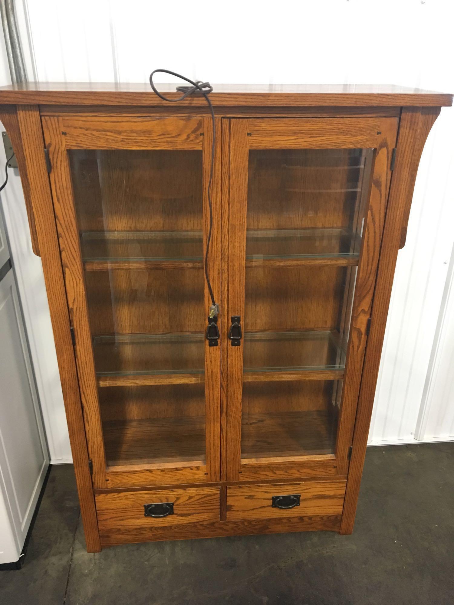 Oak lighted curio cabinet by A.A. LAUN