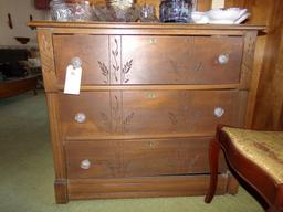 THREE DRAWER BUREAU WITH BRASS KEY HOLE GLASS PULLS AND CARVED DRAWERS