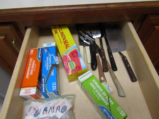 CONTENTS OF 2 DRAWERS INCLUDING COOKING UTENSILS PLASTIC WRAPS AND MORE