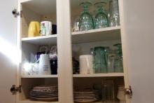 CONTENTS OF CABINET INCLUDING DISHES GLASSWARE AND MORE