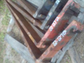 A SET OF ORANGE FORKLIFT FORKS