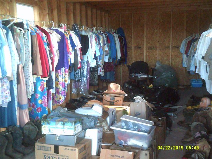 CLOTHES AND MISC ITEMS INSIDE STORAGE BUILDING