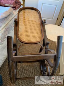 Wooden rocking chair with end table.