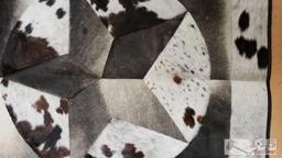 Cowhide rug with longhorn and star design.