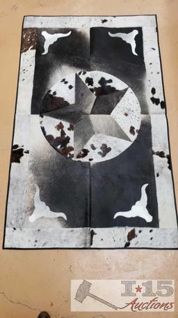 Cowhide rug with longhorn and star design.