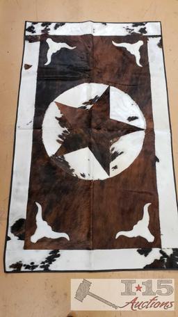 Cowhide rug with longhorn and star design.