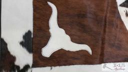 Cowhide rug with longhorn and star design.