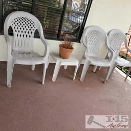 3 White Plastic Chairs, End Table and Pottery