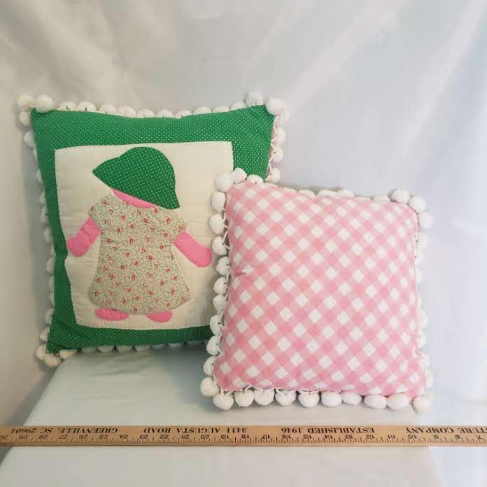 Lot 2 Accent Pillows – 1 Appliqued Doll & 1 Pink & White Checkered – both w/ Pom Pom Fringe