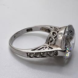 Sterling Silver Ring with Large Clear Stone & Small Stones on Band