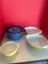 3 yellow Pyrex bowls and blue panini ceramic pot