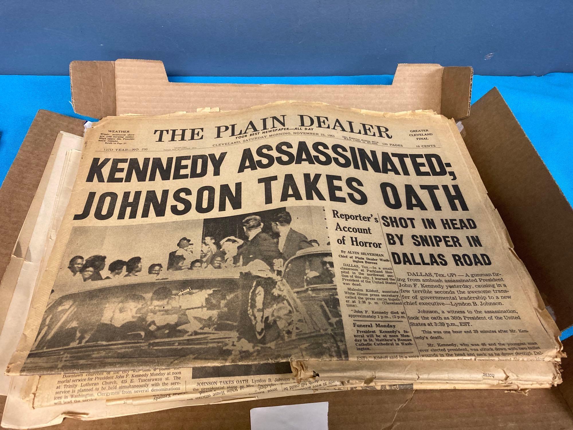 JFK book and newspapers about assassination