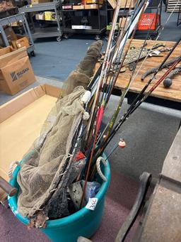 Tote full of fishing nets rods reels