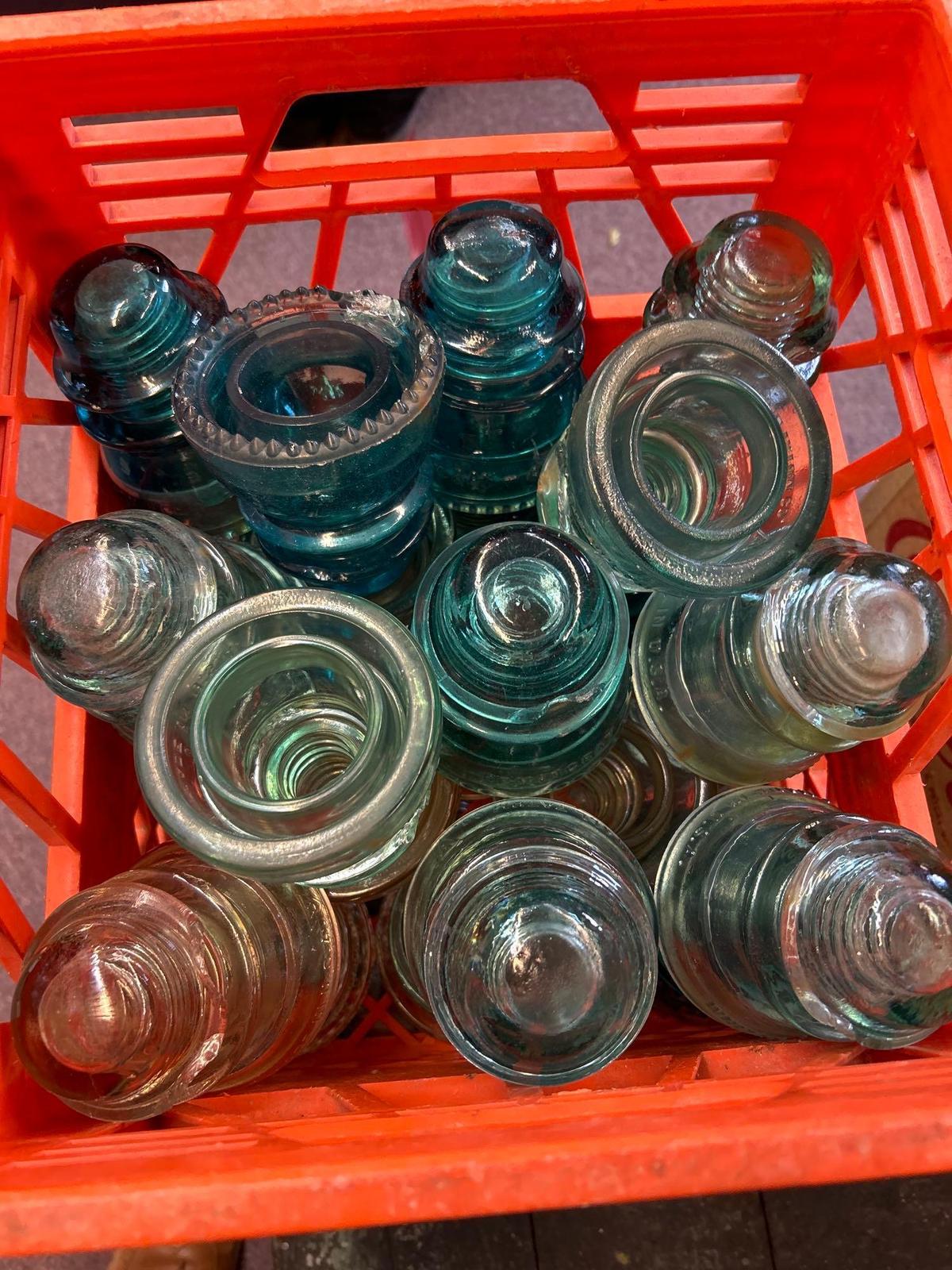 2 milk crates, full of vintage, electric insulators blue