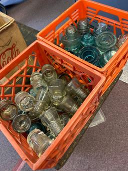 2 milk crates, full of vintage, electric insulators blue