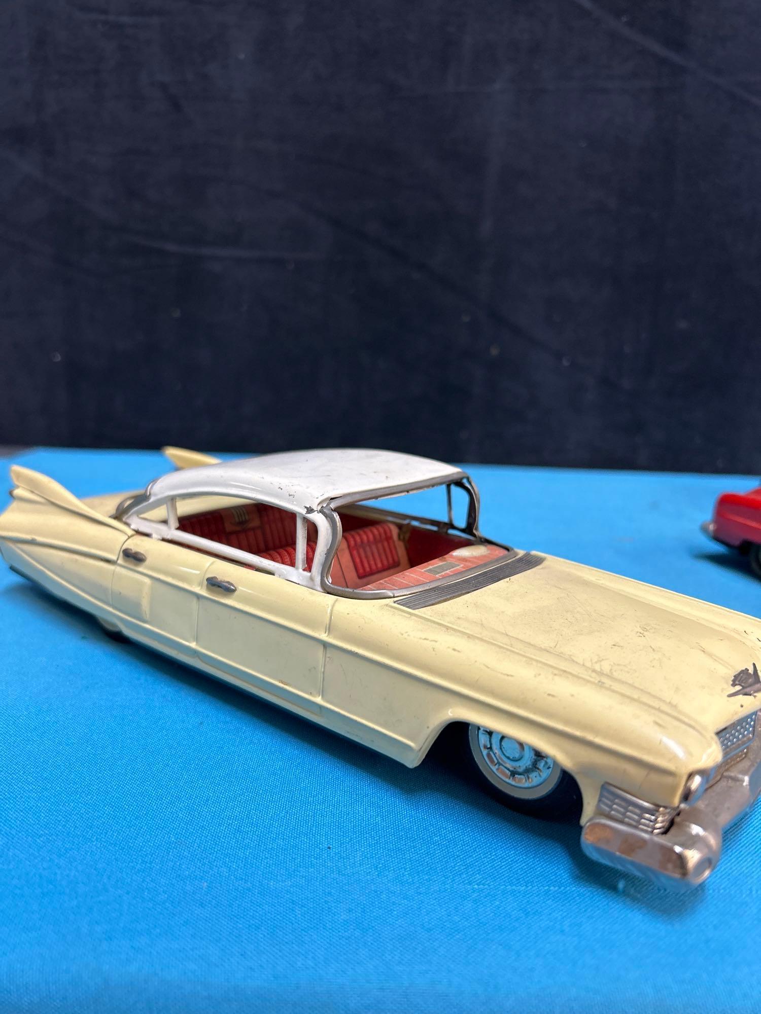 4 vintage friction toy cars Cadillac Buick jaguar