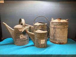 3 galvanized watering cans and a fuel can