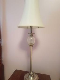 Silver lamp with glass ball on it and lamp shade
