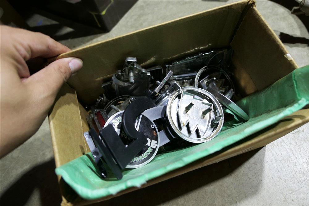 Box of assorted vintage car badges