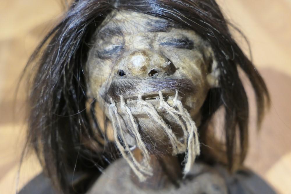 Unusual old Shrunken Head under Glass