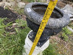 Plastic flower urn on cement base