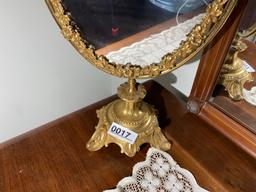 Items on bureau including elaborate mirror on stand