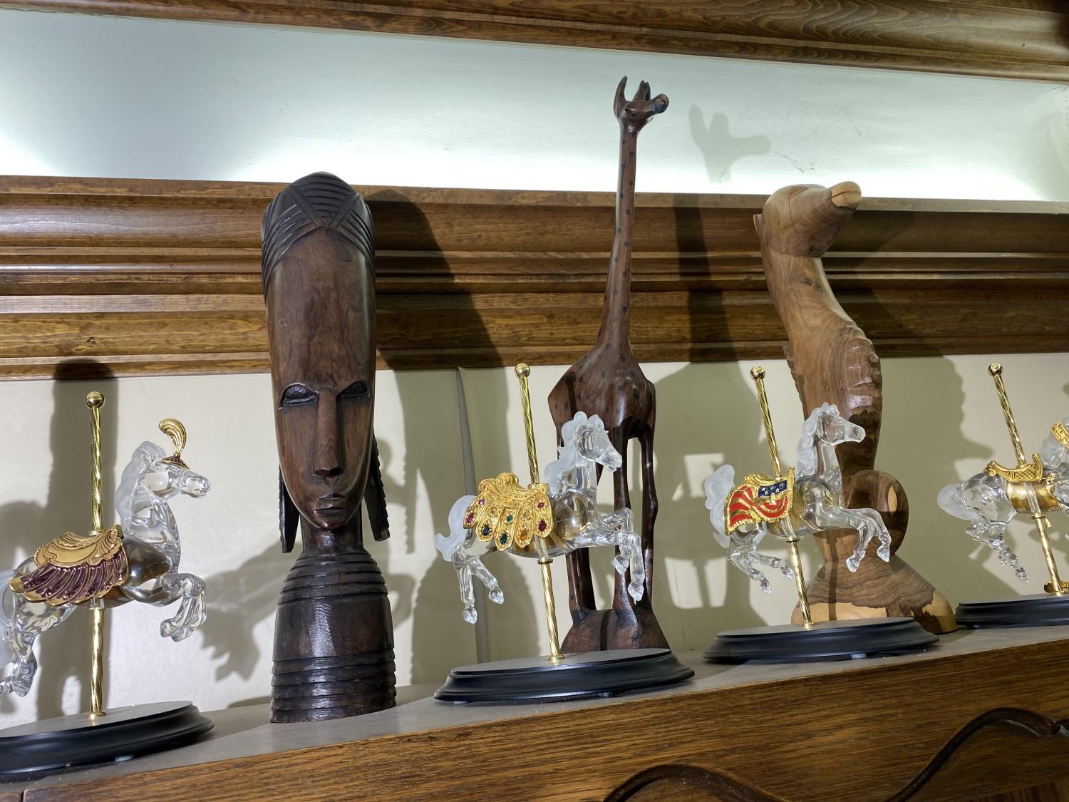 Carved tribal items on top shelf