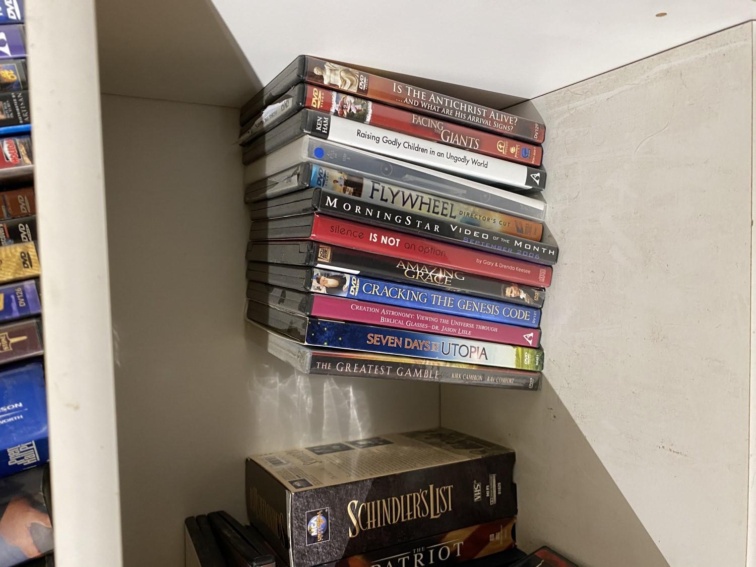 White shelf with contents - DVDs