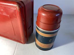 Vintage red metal lunchbox and thermos