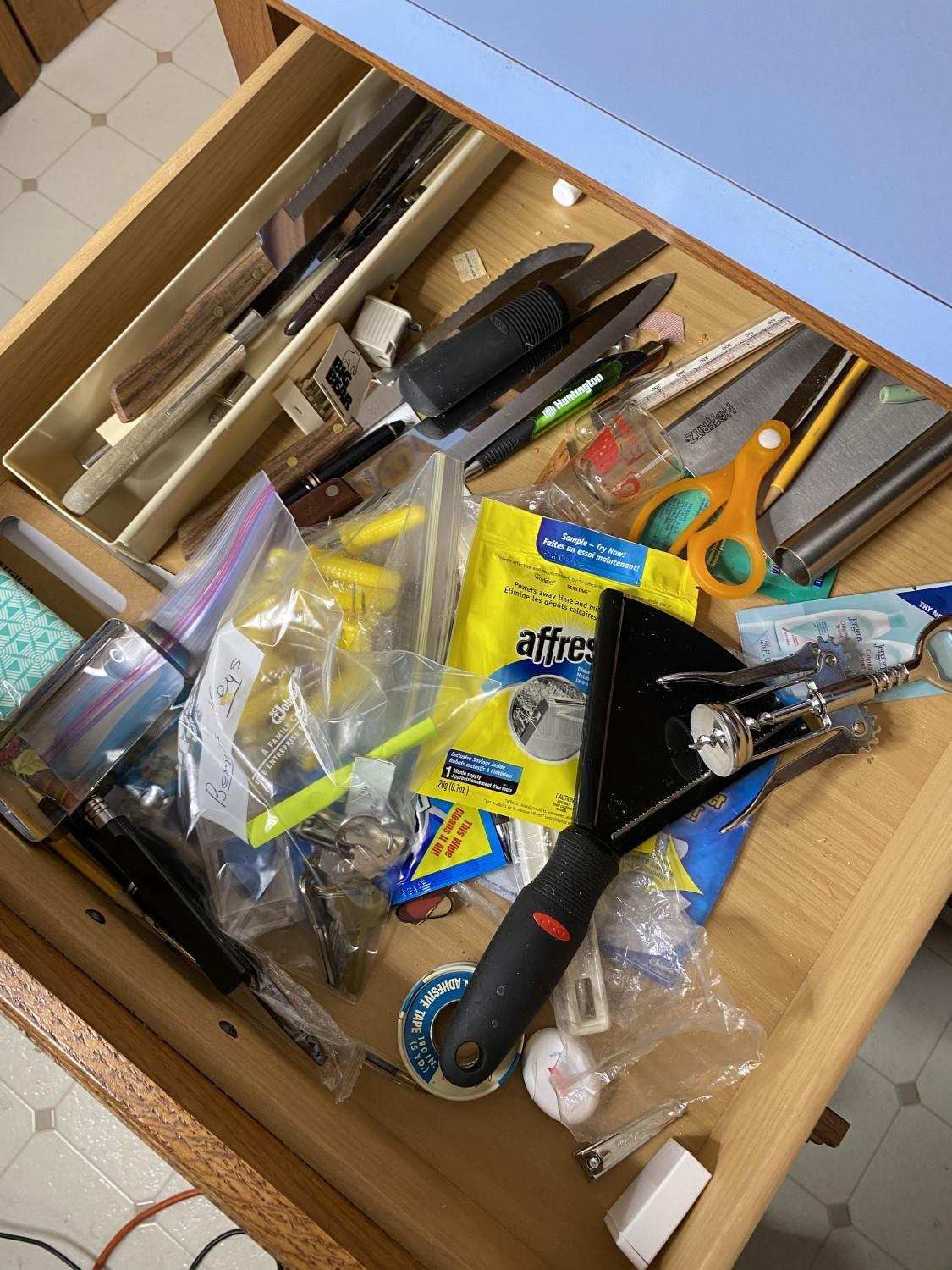 Contents of drawers including silverware, knives