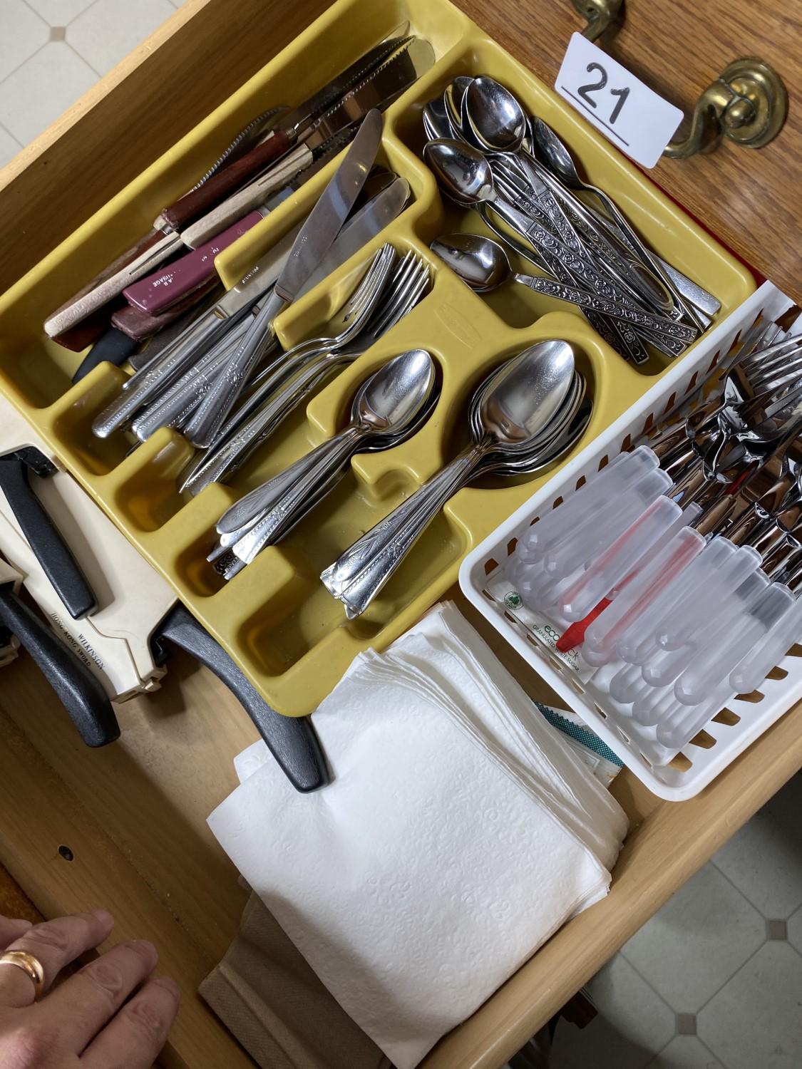 Contents of drawers including silverware, knives