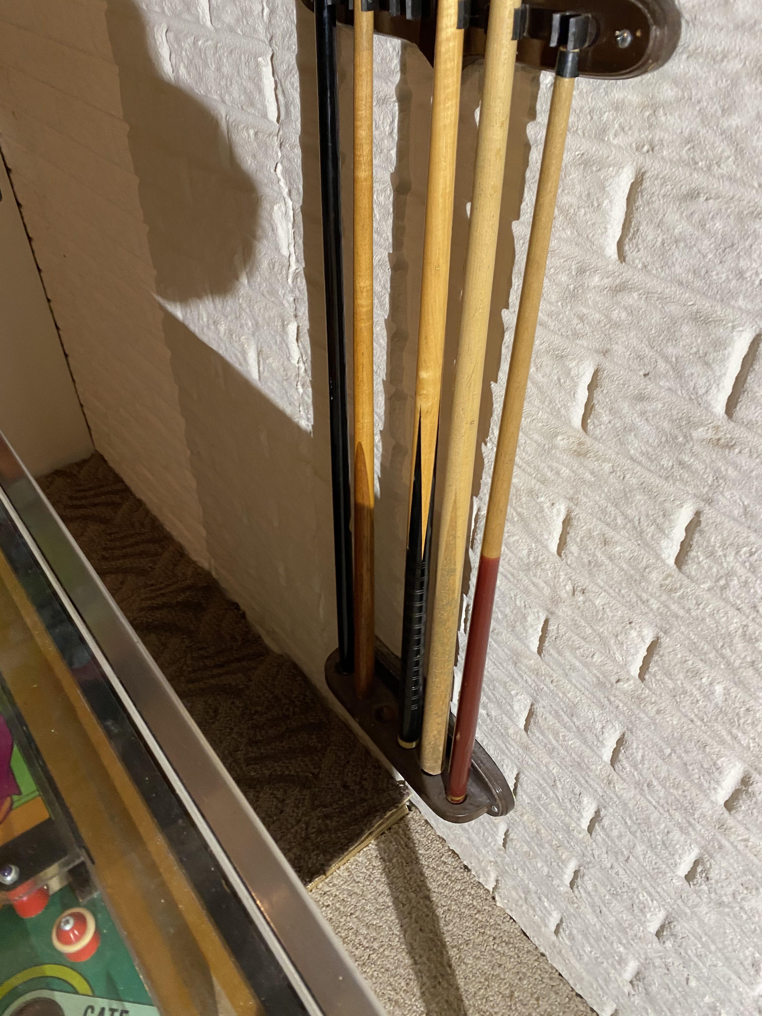 2 racks full of Vintage Pool Cue Sticks