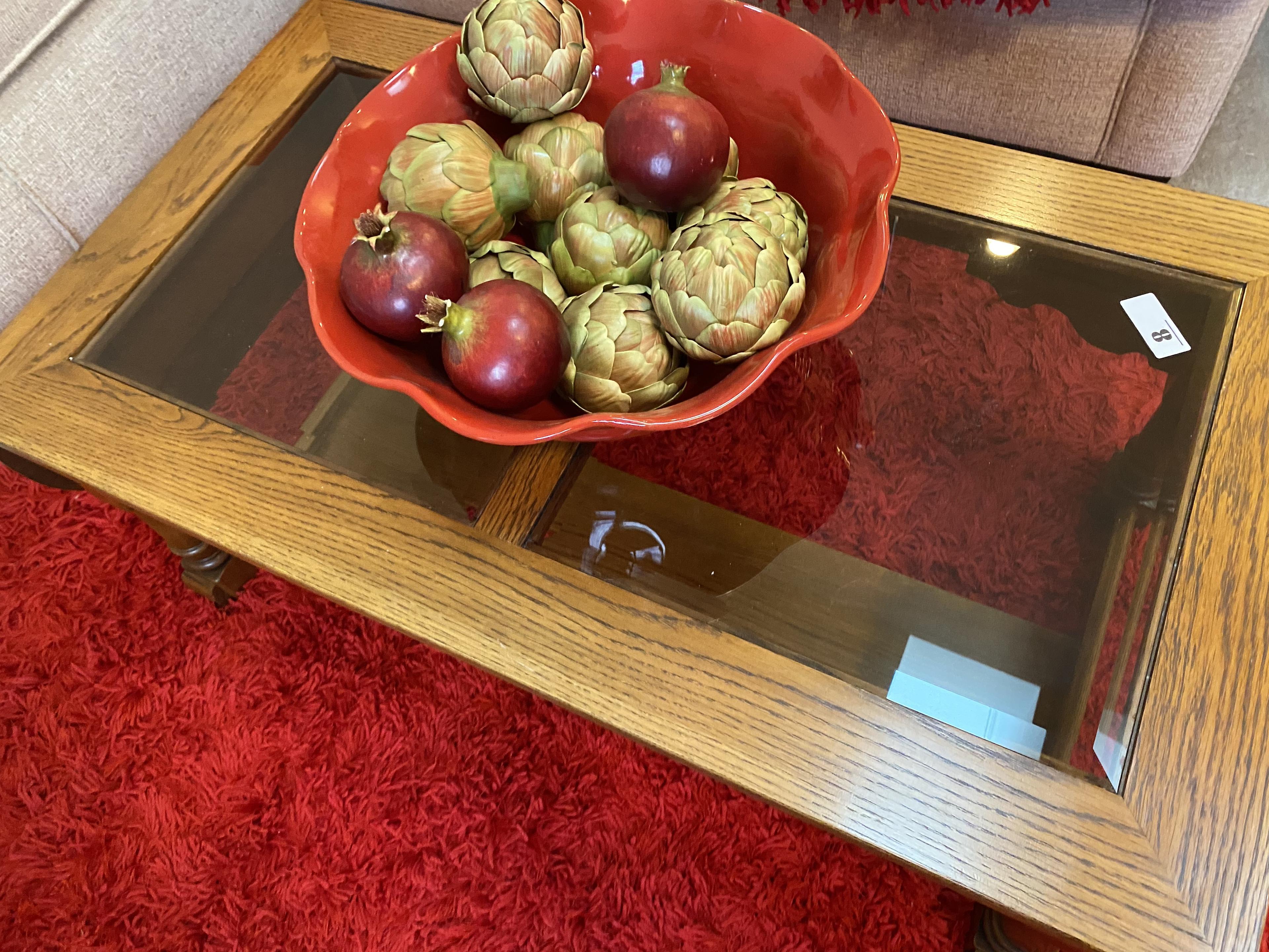 Glass topped coffee table with bowl, decorative veggies